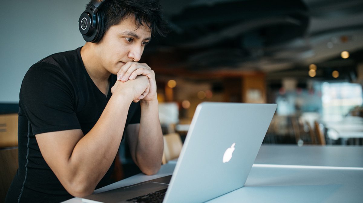 Man At Computer Watching Webinar or Live Stream Video