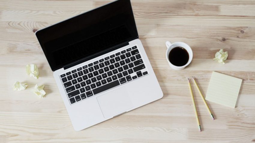 Laptop on desk with coffee