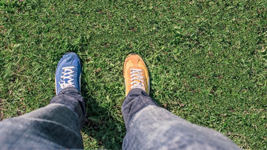 Person with two different colored shoes on